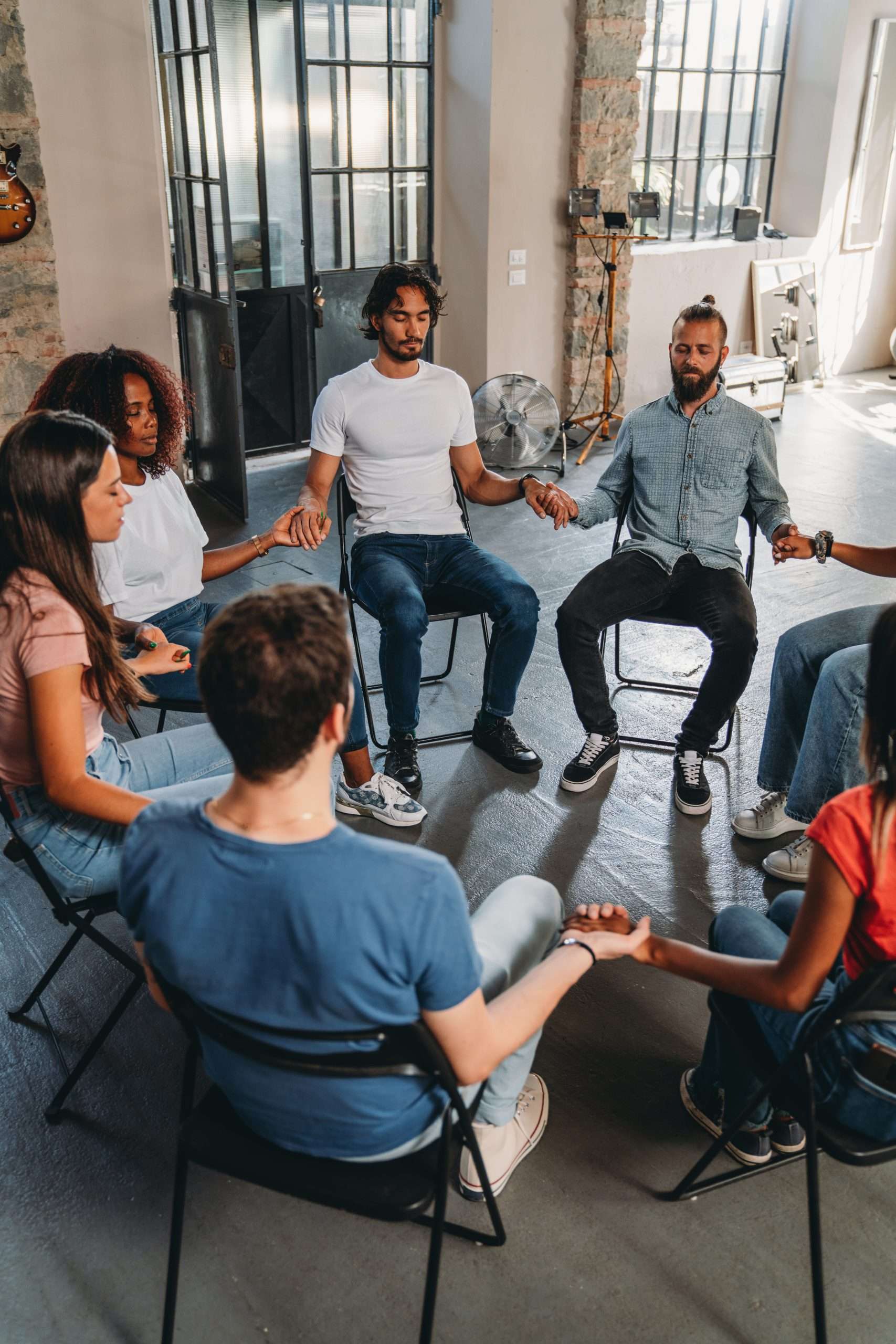 People are meditating together during a group therapy session 12-step integration in Frisco, Texas